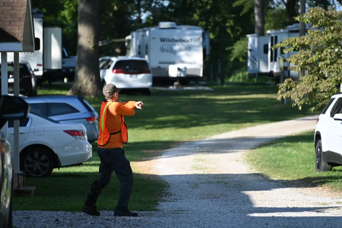 Campers and RVs parked along the shaded loop road